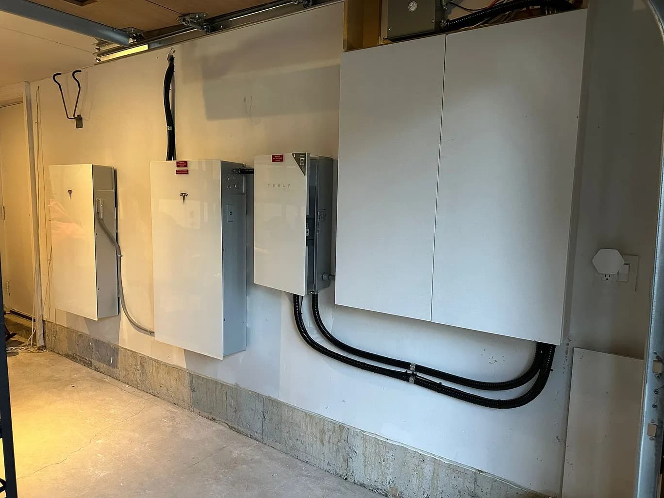 Tesla Powerwall 3 battery storage system installed on a Canadian residential home alongside solar panels — generator vs battery backup comparison