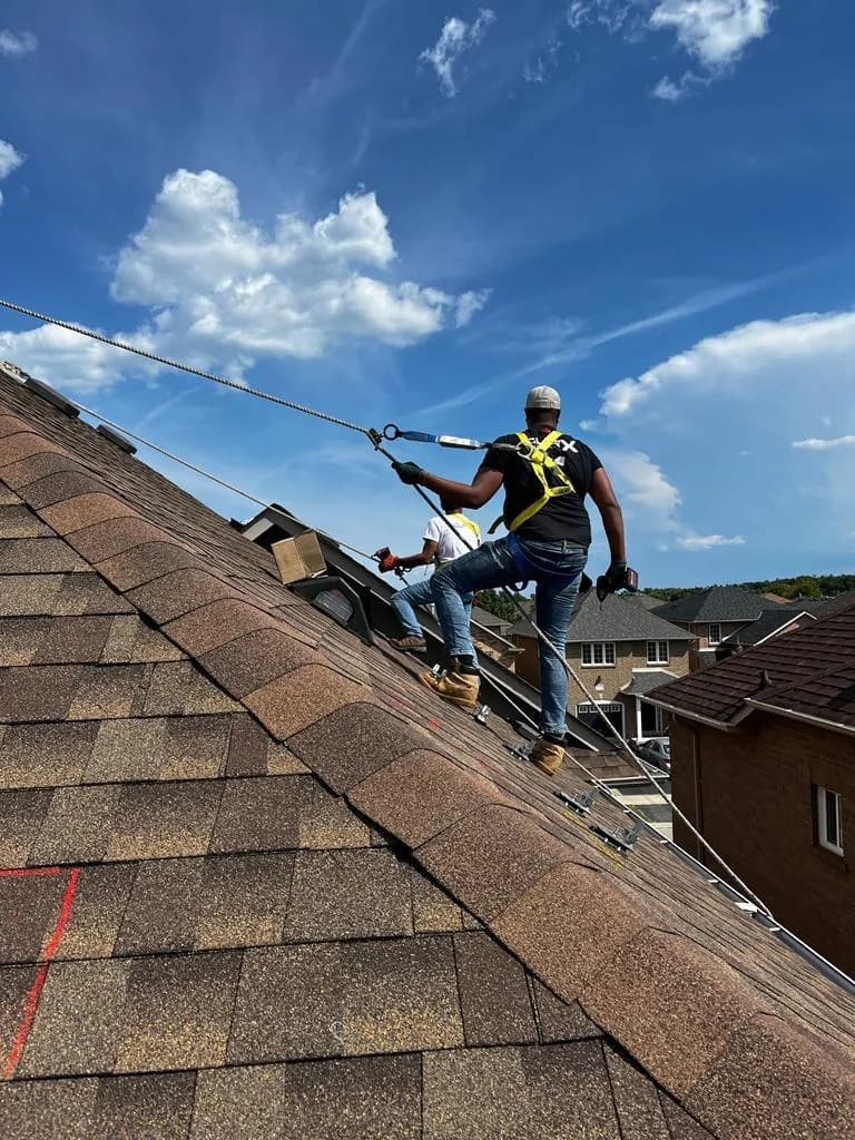 Solar X crew installing premium black-on-black solar panels on a residential roof in Canada